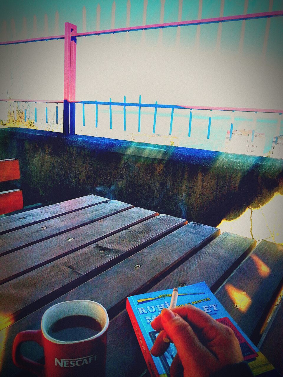 chair, high angle view, table, day, empty, text, communication, wood - material, absence, no people, built structure, outdoors, western script, architecture, seat, railing, book, close-up, bench, water