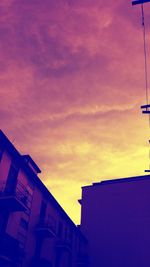 Low angle view of building against sky at sunset