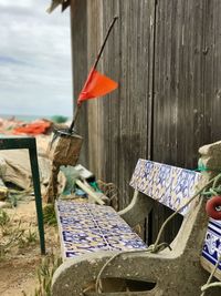 Close-up of flags hanging against wooden wall