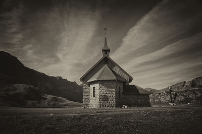 Low angle view of old chapel against sky