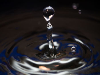 Close-up of drop falling on water