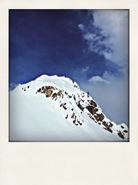 Scenic view of snow covered mountains against sky