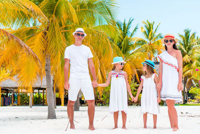 Portrait of people on palm trees