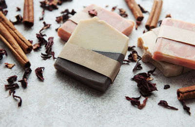 Spa setting witn natural handmade soap with cinnamon and flower petals