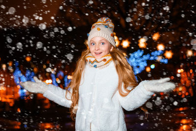 Portrait of smiling girl during winter at night