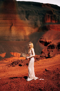 Full length of woman standing on rock