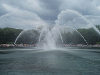 Fountain in park against sky