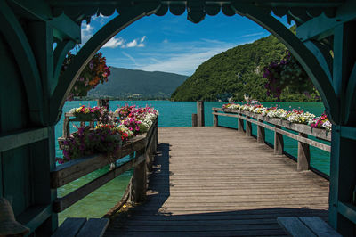 Pier with flowers on the annecy lake at the village of talloires, france.