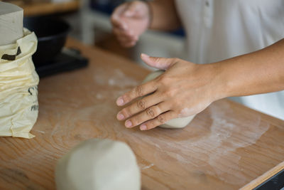 Midsection of woman preparing food on table