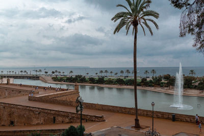 Swimming pool by sea against sky