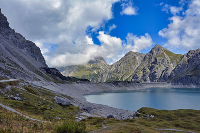 Scenic view of lake and mountains against sky