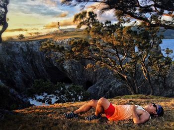 Woman lying on rock