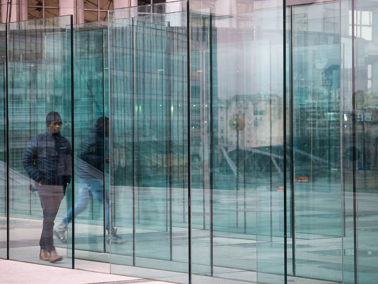 glass - material, window, reflection, one person, adults only, office building exterior, full length, business, adult, looking through window, one man only, people, only men, well-dressed, day, men, corporate business, office, outdoors, building exterior, businessman, young adult