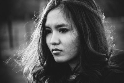 Close-up of thoughtful young woman looking away