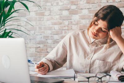 Young woman using laptop at table