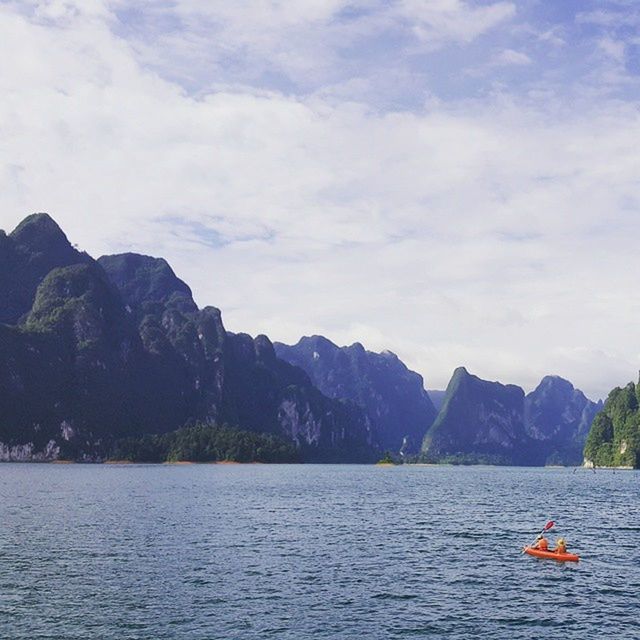 SCENIC VIEW OF SEA WITH MOUNTAINS IN BACKGROUND