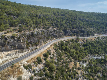 High angle view of road amidst trees against sky