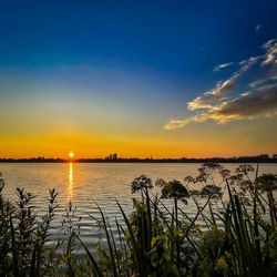 Scenic view of lake against sky during sunset