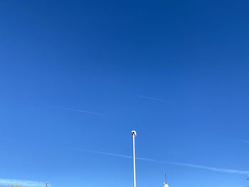 Low angle view of street light against clear blue sky