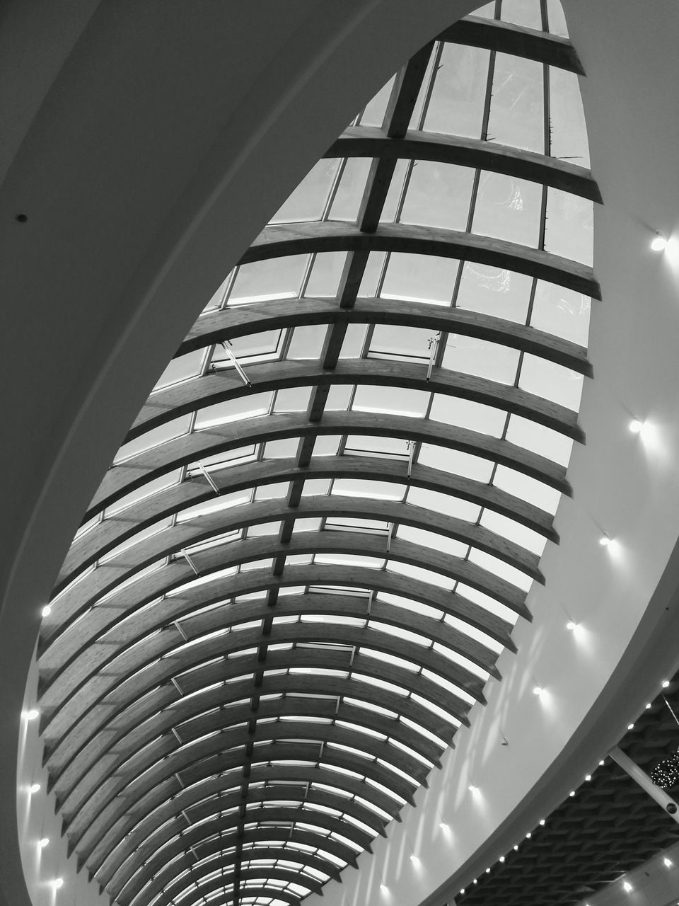 architecture, built structure, low angle view, building exterior, modern, sky, building, glass - material, city, office building, architectural feature, indoors, window, tall - high, no people, reflection, day, pattern, skyscraper, tower