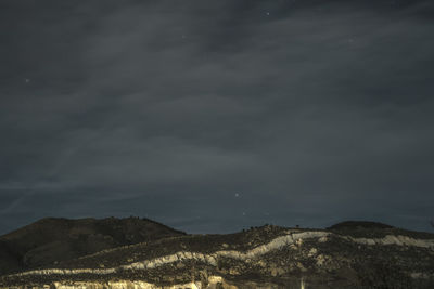 Scenic view of mountains against sky at night