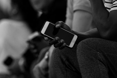 Close-up of man holding mobile phone