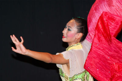 Young woman with red flag dancing