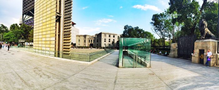 Empty road with buildings in background