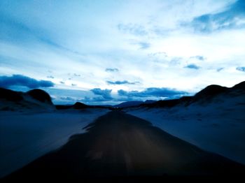 Panoramic view of snowcapped mountains against sky during sunset