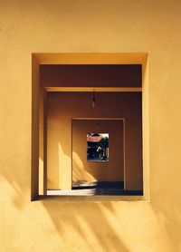 Woman with open door of building