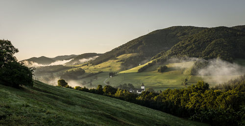 Scenic view of landscape and mountains against sky