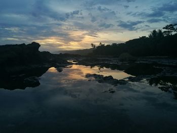 Scenic view of silhouette trees against sky at sunset