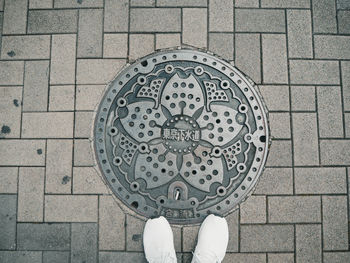 Low section of person standing on footpath