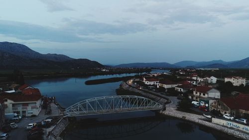 High angle view of river by buildings against sky