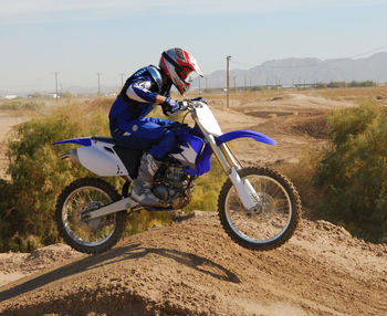 Biker riding motorcycle on field