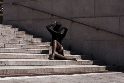 Woman sitting on staircase