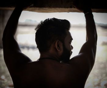 Close-up portrait of shirtless man