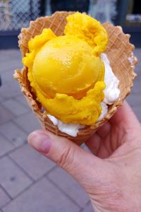 Close-up of hand holding ice cream