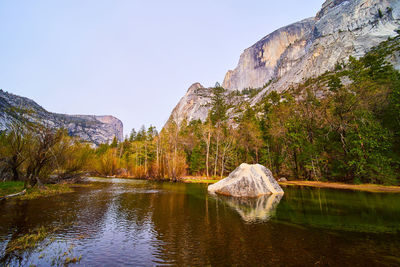 Scenic view of lake and mountains against clear sky