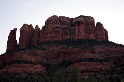 Low angle view of rock formation against clear sky