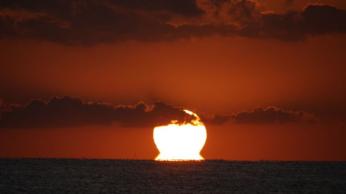 Scenic view of sea against orange sky