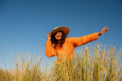 Happy female tourist smiles in the wind