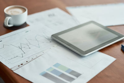 High angle view of woman using digital tablet on table