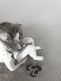 High angle view of woman sitting at beach