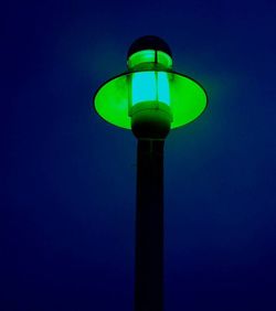 Close-up of illuminated light bulb against black background