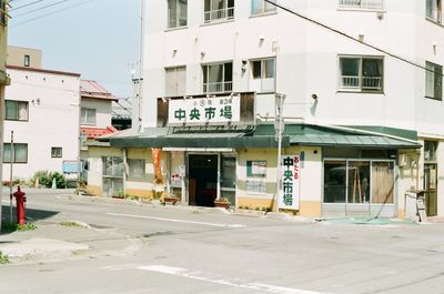 Road sign on street by buildings in city