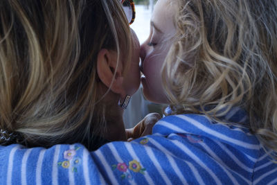 Close-up portrait of mother with daughter