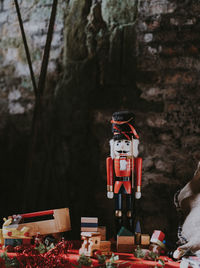 Soldier figurine and toy blocks on table against weathered wall at home