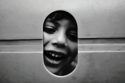 Portrait of smiling boy looking through hole