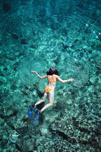 High angle view of woman snorkeling in sea